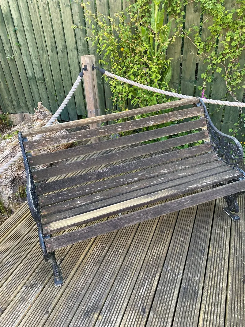 Before: weathered garden bench with worn wooden slats